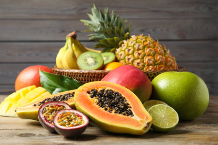 Fresh ripe papaya and other fruits on wooden tableの写真素材