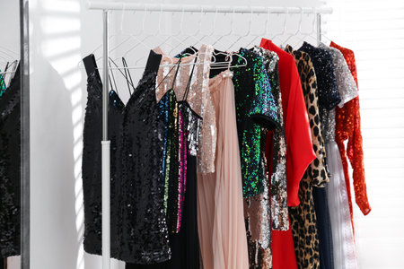 Different stylish women's clothes on rack indoorsの写真素材