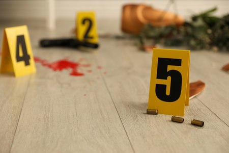Crime scene markers and casings on floor indoorsの写真素材