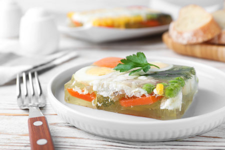 Delicious fish aspic served on white wooden table, closeupの写真素材
