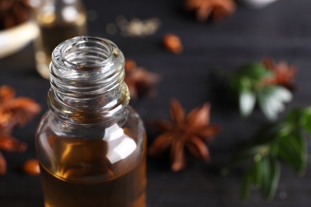 Anise essential oil in bottle on table, closeup. Space for textの写真素材