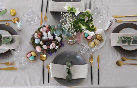 Beautiful Easter table setting with festive decor, flat layの写真素材