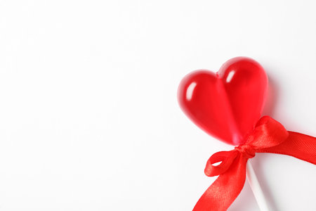 Sweet heart shaped lollipop on white background, top view with space for text. Valentine's day celebrationの写真素材