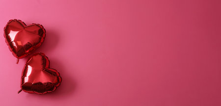 Red heart shaped balloons on pink background, flat lay with space for text. Saint Valentine's day celebrationの写真素材