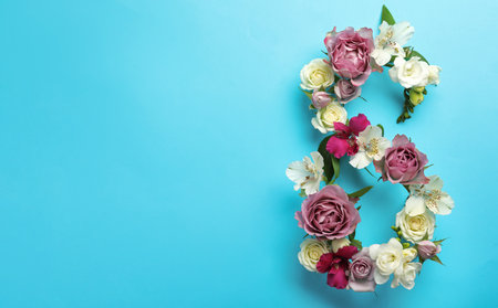 Number 8 made of beautiful flowers on light blue background, flat lay with space for text. International Women's dayの写真素材