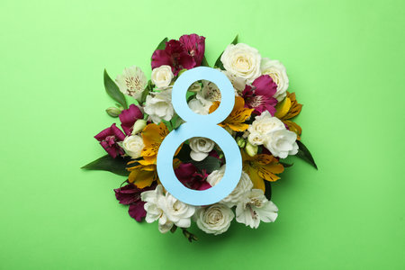 8 March greeting card design with beautiful flowers on green background, flat lay. International Women's dayの写真素材