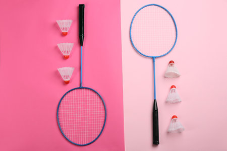 Rackets and shuttlecocks on color background, flat lay. Badminton equipmentの写真素材