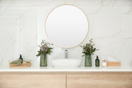 Modern bathroom interior with stylish mirror and vessel sinkの写真素材