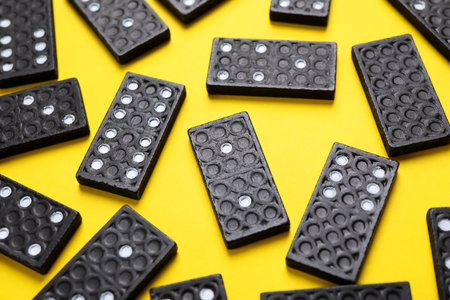 Set of black domino tiles on yellow backgroundの写真素材