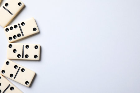 Classic domino tiles on white background, flat lay. Space for textの写真素材