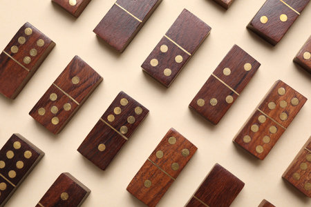 Wooden domino tiles on beige background, flat layの写真素材