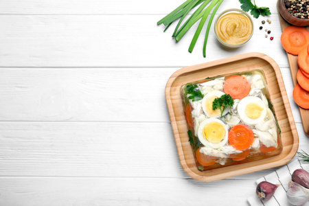 Delicious fish aspic served on white wooden table, flat lay. Space for text