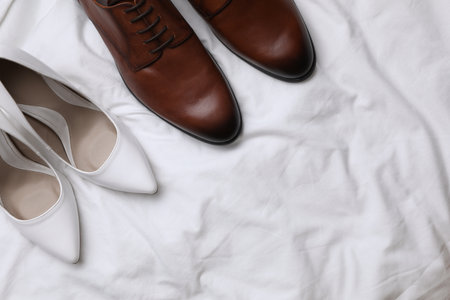 Wedding shoes on white fabric, flat lay. Space for textの写真素材