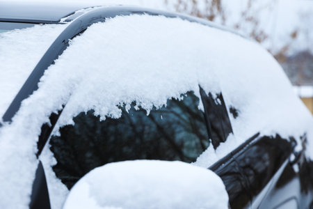 Modern car covered with snow outdoors on winter day, closeup. Frosty weatherの写真素材