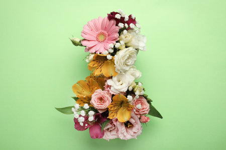 Number 8 made of beautiful flowers on green background, flat lay. International Women's dayの写真素材