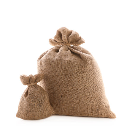 Tied burlap bags on white background. Organic materialの写真素材