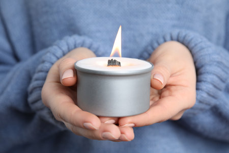 Woman holding burning candle with wooden wick, closeupの写真素材