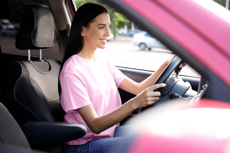 Young woman sitting in car. driving schoolの写真素材