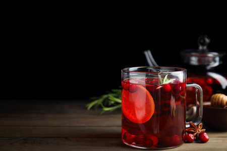 Tasty hot cranberry tea with rosemary and lemon on wooden table. Space for textの写真素材