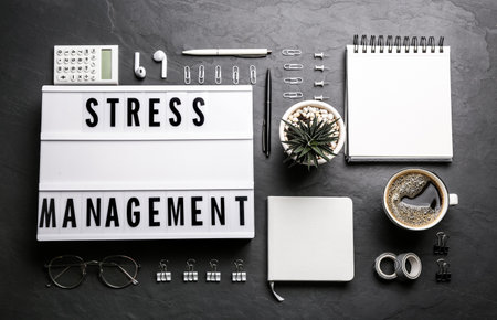 Flat lay composition of lightbox with phrase Stress Management on black backgroundの写真素材