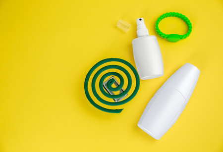 Set of different insect repellents on yellow background flat lay. Space for textの写真素材