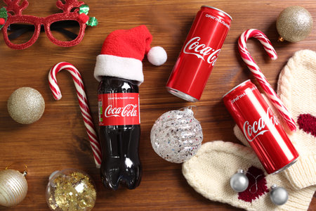 MYKOLAIV, UKRAINE - January 01, 2021: Flat lay composition with Coca-Cola drinks and Christmas decorations on wooden backgroundのeditorial素材