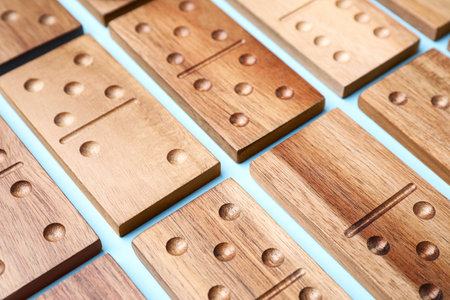 Wooden domino tiles on light blue background, closeupの写真素材