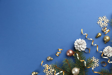 Flat lay composition with serpentine streamers and Christmas decor on blue background. Space for textの写真素材