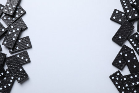 Black domino tiles on white background, flat lay. Space for textの写真素材