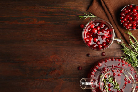 Tasty hot cranberry tea on wooden table, flat lay. Space for textの写真素材