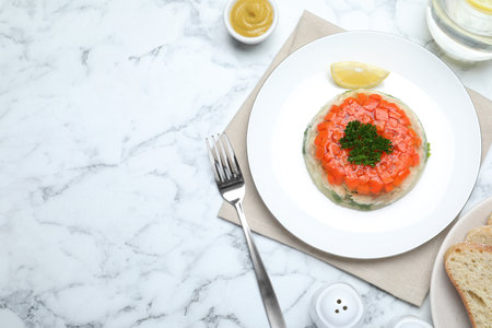 Delicious fish aspic served on white marble table, flat lay. Space for textの写真素材