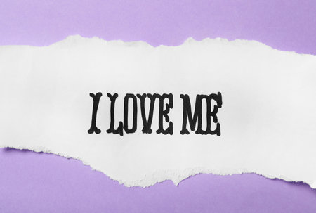Paper with handwritten phrase I Love Me on violet background, top viewの写真素材
