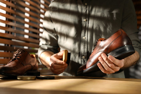 Master taking care of shoes in his workshop, closeupの写真素材