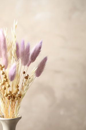 Dried flowers in vase against light gray backgroundの写真素材