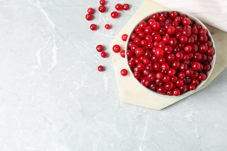 Tasty ripe cranberries on light gray marble table, flat lay. Space for textの写真素材