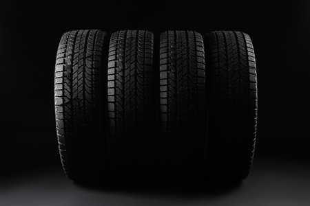 Set of winter tires on black backgroundの写真素材