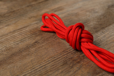 Red shoelaces on wooden background. Style accessoryの写真素材