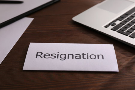 Resignation letter on wooden table in officeの写真素材