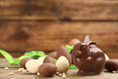 Chocolate Easter bunny and eggs on wooden table. Space for textの写真素材
