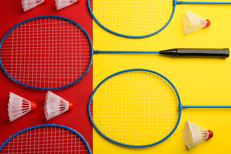 Badminton rackets and shuttlecocks on color background, flat layの写真素材