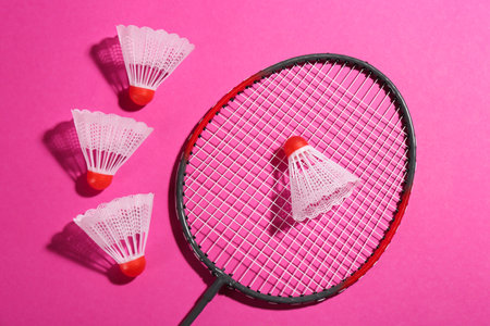 Badminton racket and shuttlecocks on pink background, flat layの写真素材