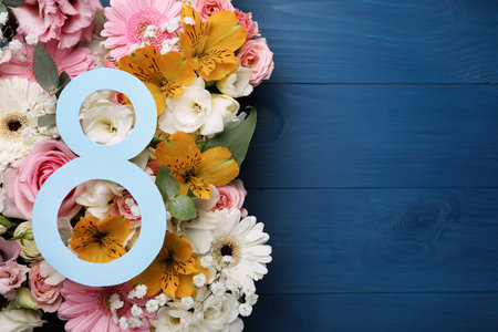 8 March greeting card design with beautiful flowers on blue wooden table, flat lay and space for...