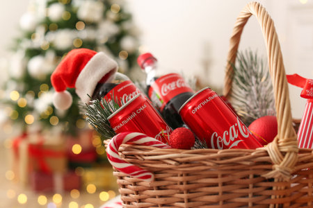 MYKOLAIV, UKRAINE - January 01, 2021: Basket with Coca-Cola drinks against blurred Christmas treeのeditorial素材