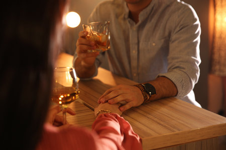Man and woman flirting with each other in bar, closeupの写真素材