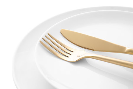 Stylish shiny cutlery and plates on white background, closeupの写真素材