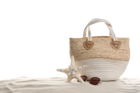Stylish bag, sunglasses and starfish on sand against white background. beach accessoriesの写真素材