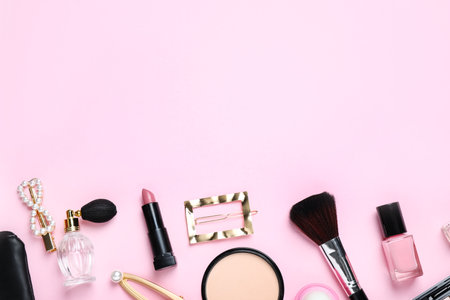 Makeup brushes and cosmetic products on pink background, flat lay. Space for textの写真素材