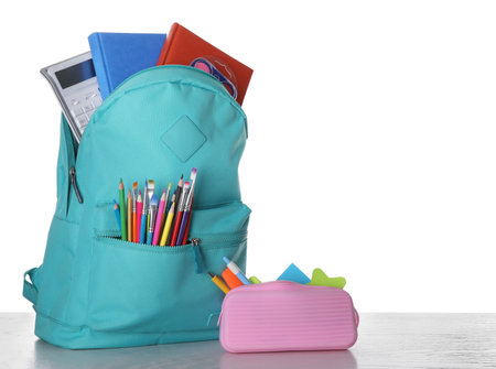 Modern backpack with stationery on white backgroundの写真素材
