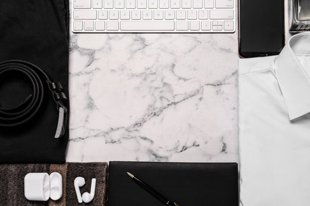 Frame of stylish clothes, gadgets and accessories on white marble background, flat lay. Space for textの写真素材