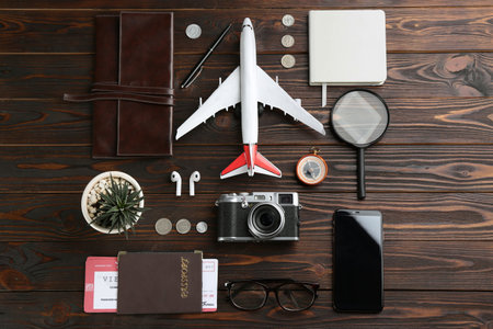 Flat lay composition with toy airplane and travel items on wooden backgroundの写真素材